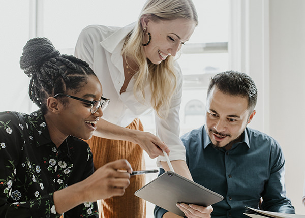 Team of two women and a man review a document